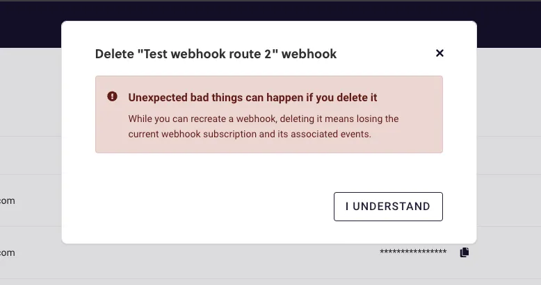 The first delete confirmation dialog in RC3, for the webhook named Test webhook route 2, over the dimmed Webhooks page. A red warning headed Unexpected bad things can happen if you delete it says that while you can recreate a webhook, deleting it means losing the current webhook subscription and its associated events. An outlined I understand button sits at the bottom right.
